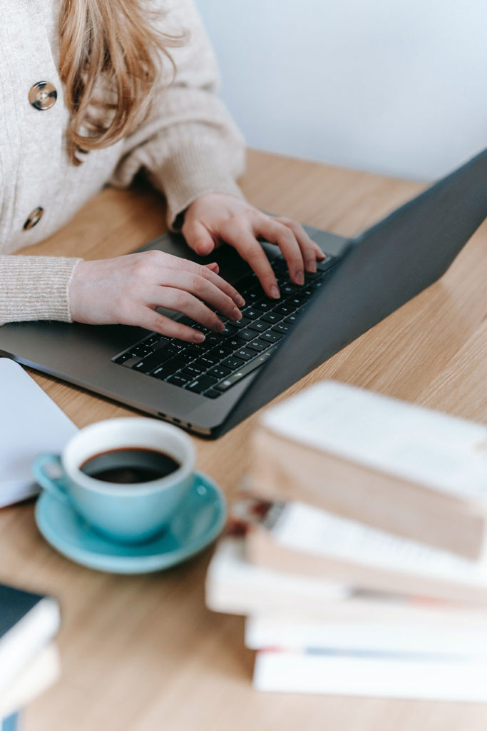 female hands on the laptop and coffee